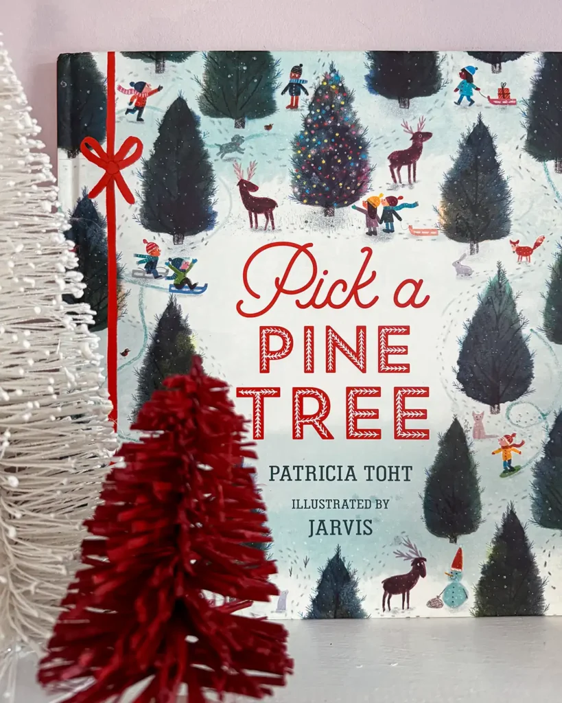 Pick A Pine Tree picture book on a child's bookshelf with red and white bottle brush trees around it