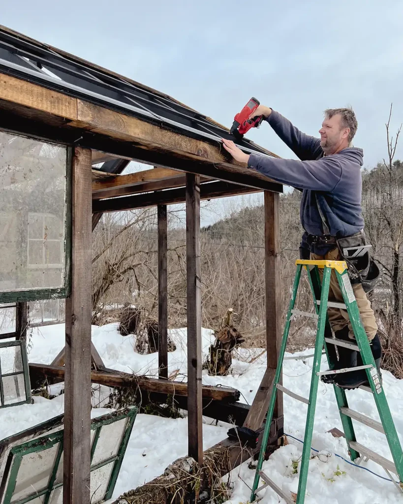 Installing drip edge on a greenhouse roof before laying the polycarbonate roofing sheets on top