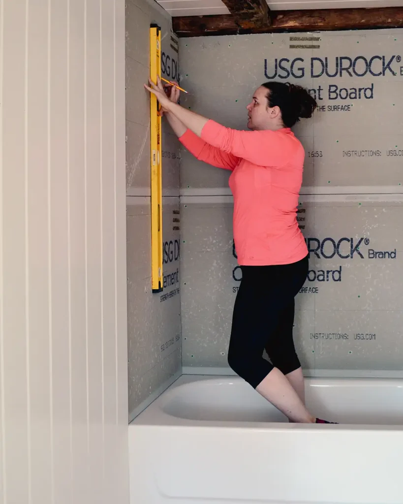 Mark tiling guide lines on the cement board using a bubble level straight edge and a pencil