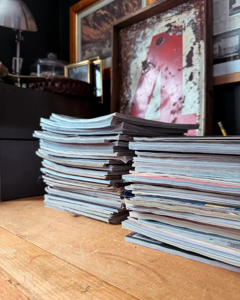 Stacks of old magazines on a desk