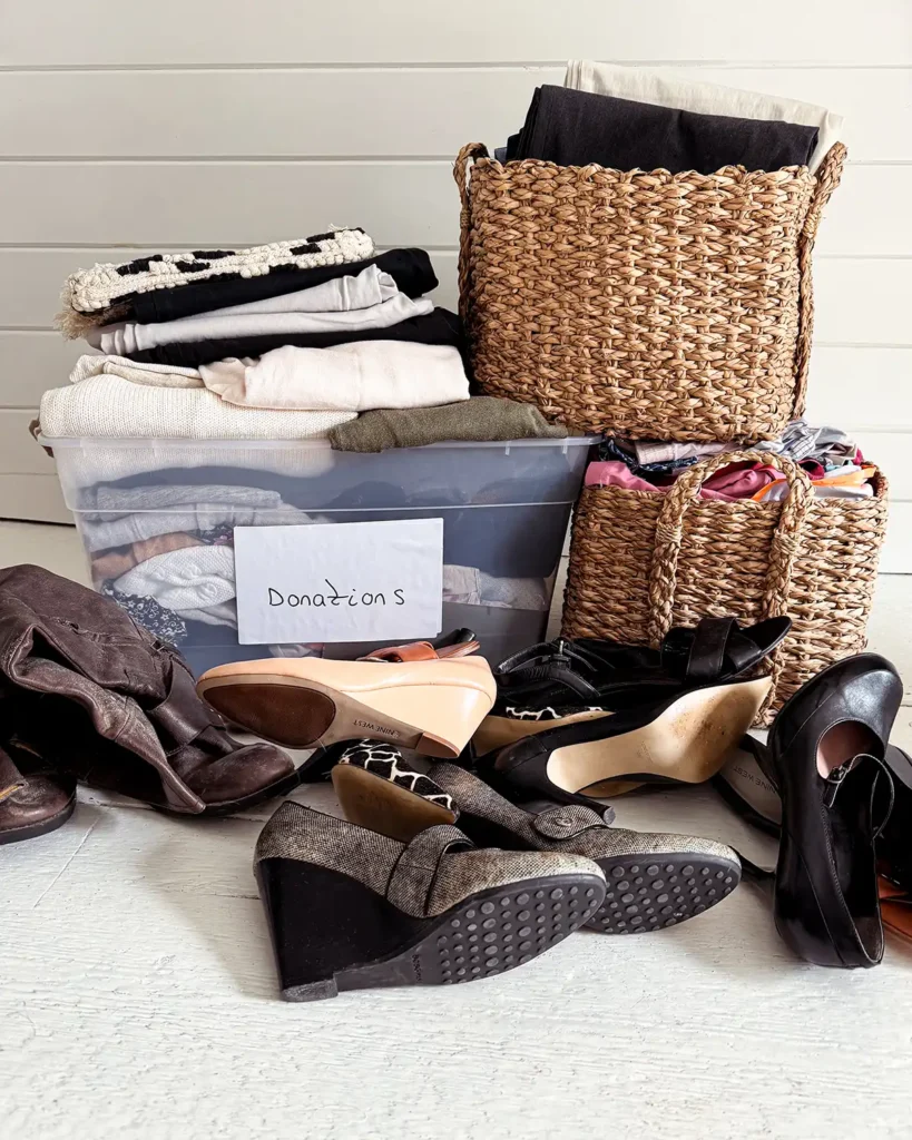 Donation box overflowing with clothes and shoes from a closet decluttering session