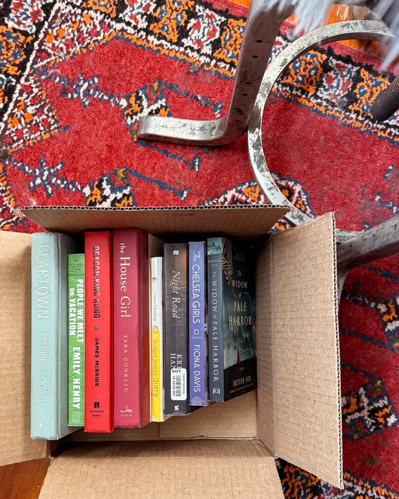 Book donations packed up in a cardboard box to be taken to the donation center