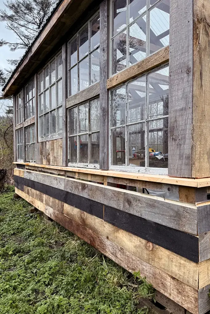 Greenhouse building progress for the month of April featured image with DIY shiplap siding under recycled window sash sides