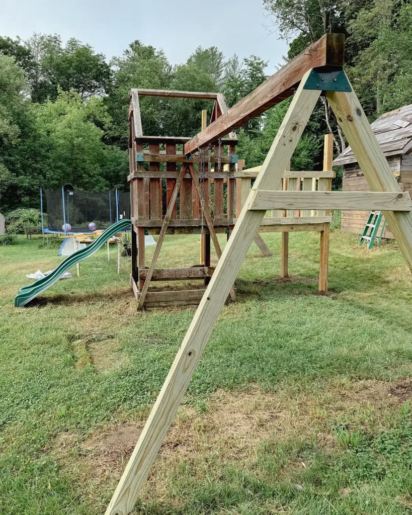Swing set renovation progress after one week, with replaced rotten wood parts and extended the deck