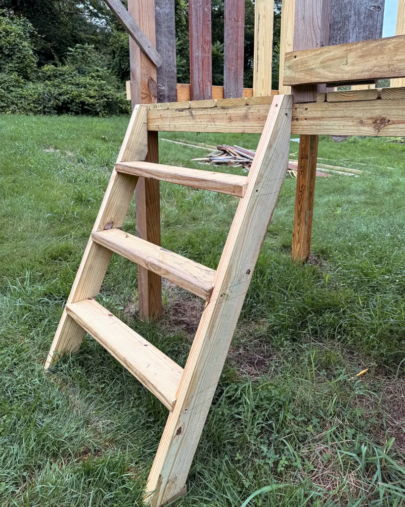 Building a playground ladder out of wood to reach the deck level of a playground