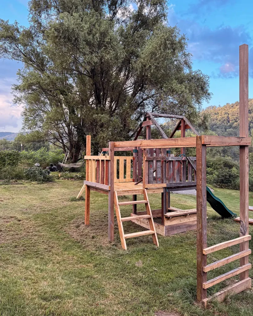 The second week of playground renovation progress with a new ladder for the deck extension, monkey bars, and a sandbox underneath the deck