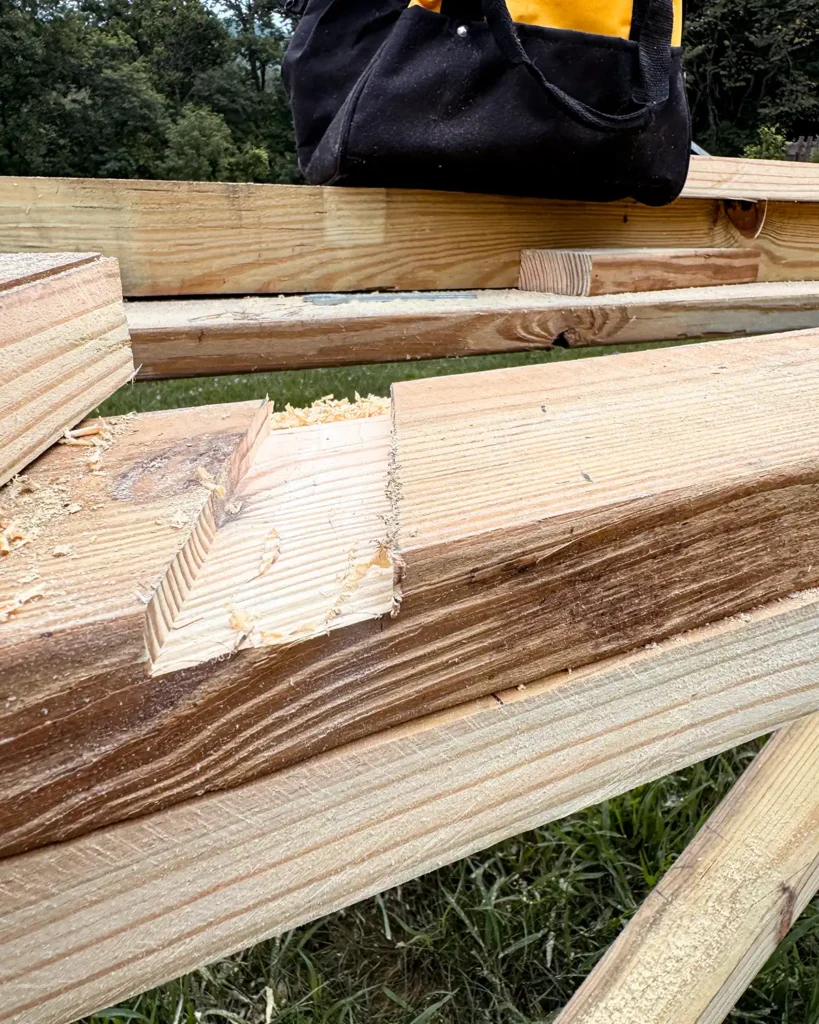 Routing grooves in pressure treated wood for the ladder steps to slide into