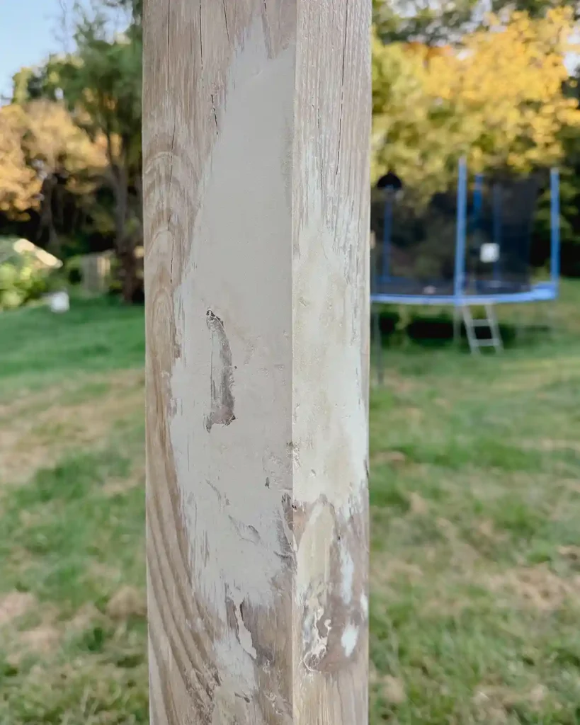 Repairing a large hole in a wooden post using Bondo wood filler and sanded smooth