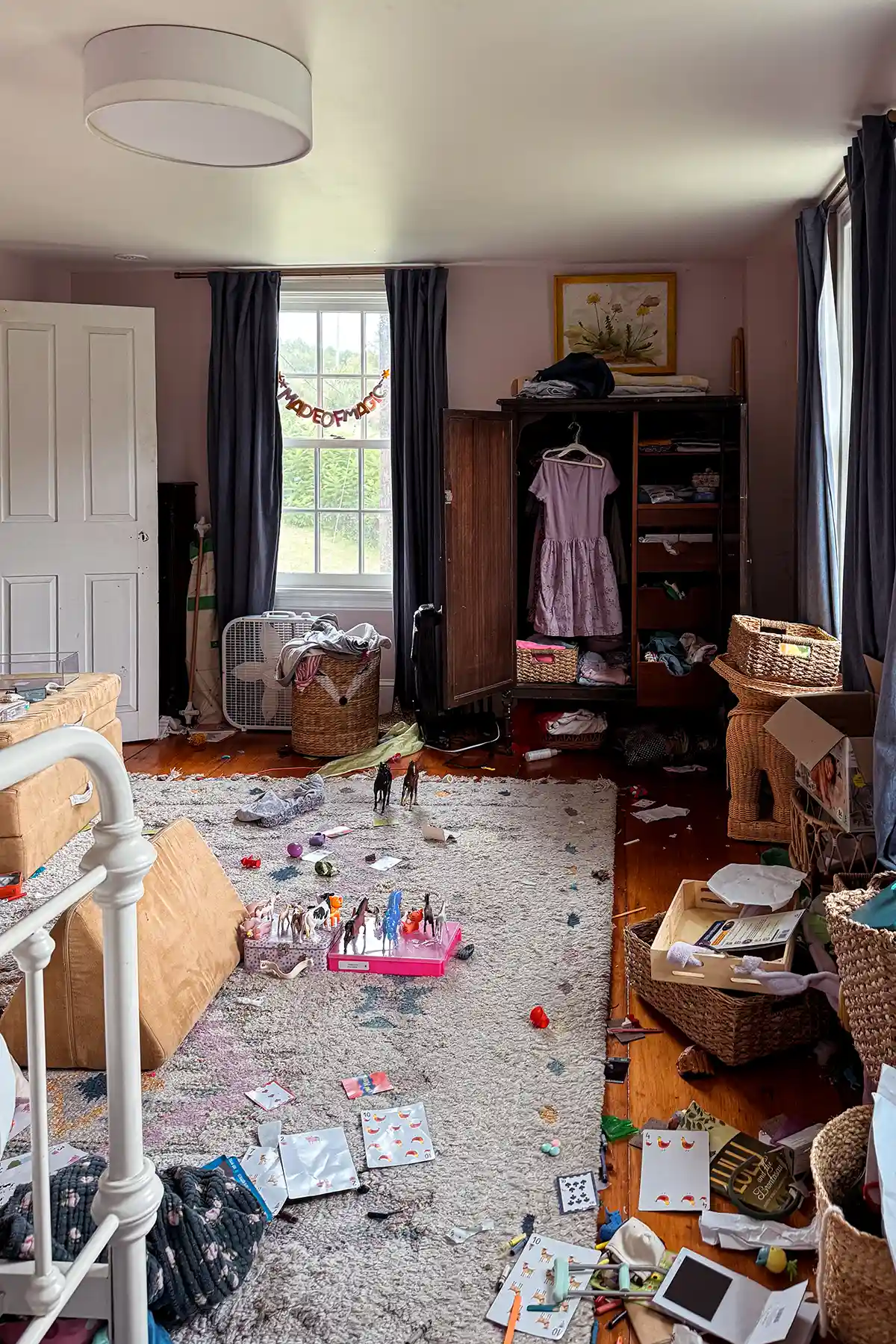 How to clean a messy room fast featured image with a kid's messy bedroom, toys and dirty clothes all over the floor, unmade bed, and little space to walk through the room