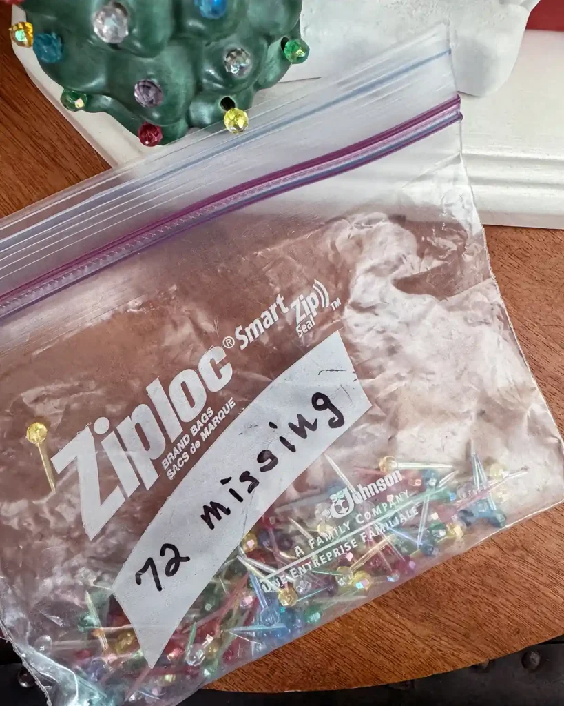 Bag of plastic lights that look like little beads that are used to decorate a ceramic house to make it look like Christmas lights are on the house