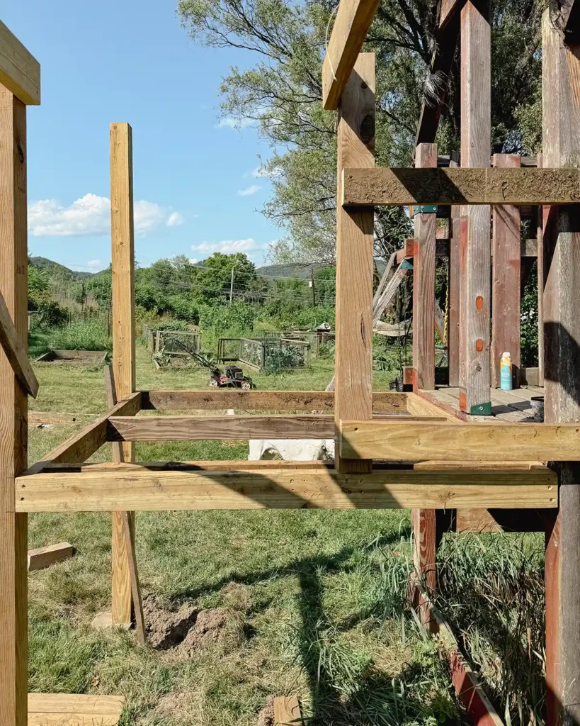 Attaching the playground deck posts to the framing and adding some more posts and framing for the addition of monkey bars off the deck