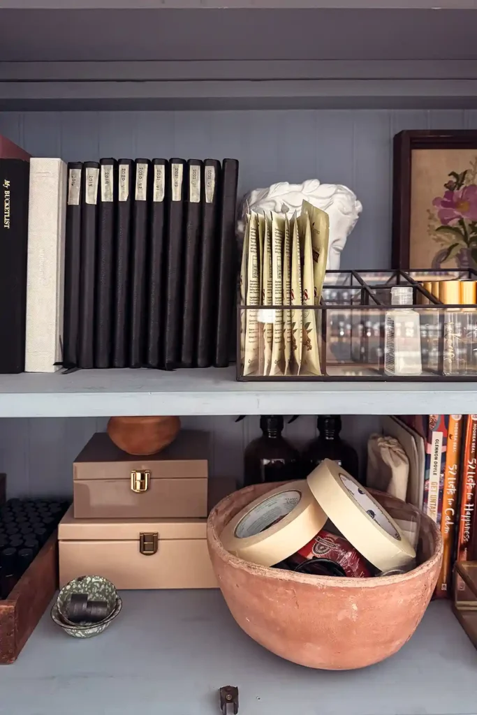 Challenging myself to declutter 10,000 items from our home including the contents of this blue cabinet with journals, notebooks, pens, markers, essential oil accessories, art, metal storage boxes, bowl of tape, books and more
