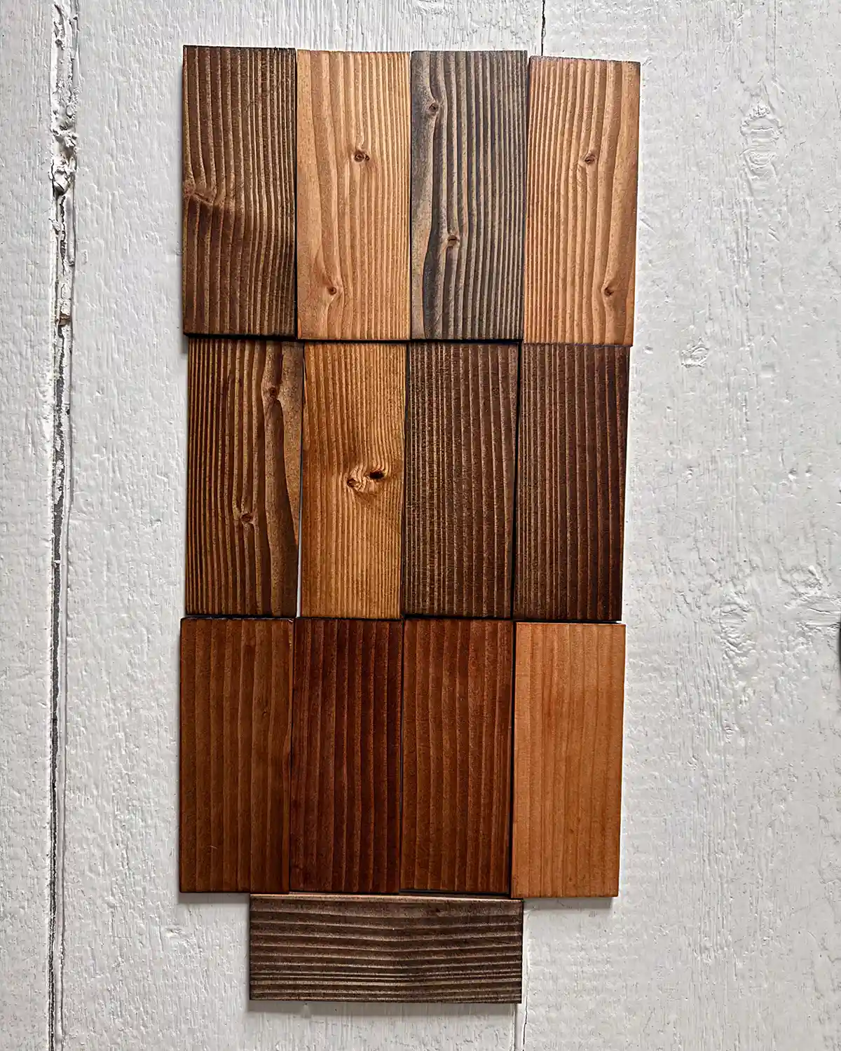 Testing all of the dark Minwax stains on samples of douglas fir wood; colors include Dark Walnut, Early American, Ebony, English Chestnut, Espresso, Honey, Jacobean, Mocha, Provincial, Red Mahogany, Red Oak, Special Walnut, and True Black