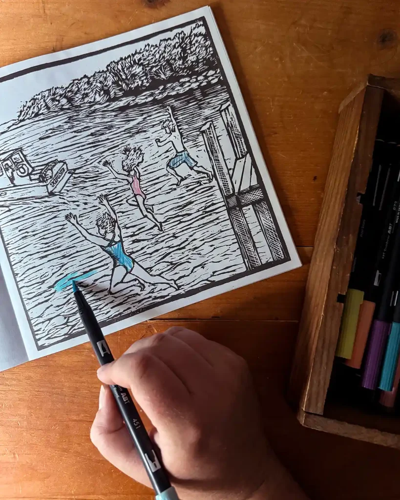 Coloring a beach scene in an adult coloring book about Maine