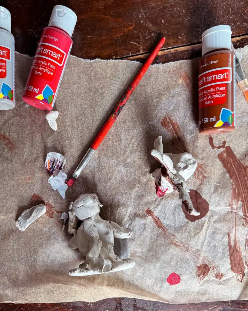 Painting clay animal creations made with kids