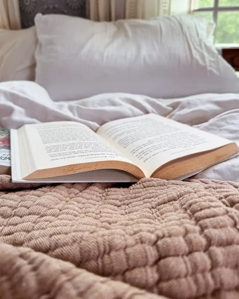 Taking a break and snuggling up in a messy bed with a thrifted book