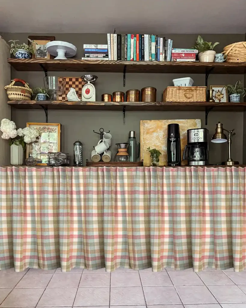 Light colored red, yellow, orange, green checked cafe curtains Photoshopped to hang over lower pantry shelves in a kitchen with open pantry shelves above