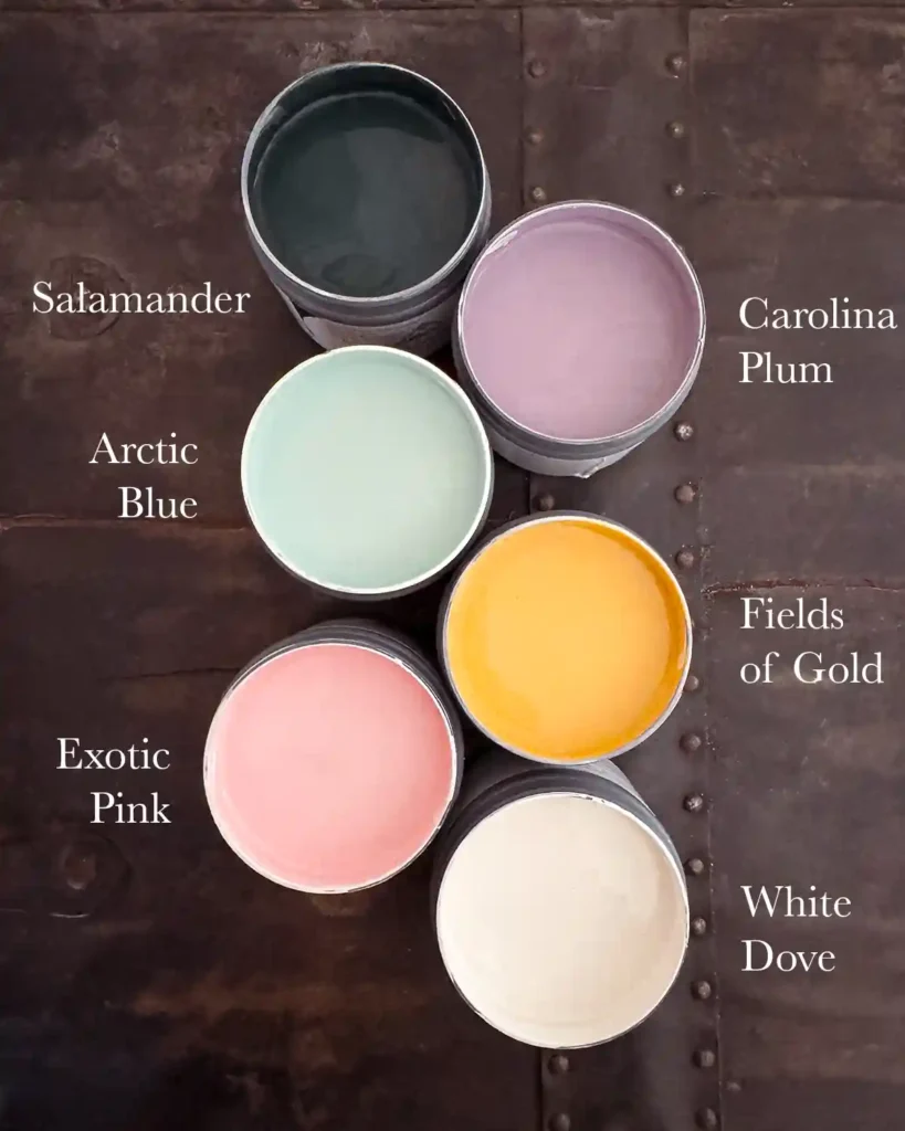 Playhouse paint color palette shown as a top down view of sample pots including a dark blue-green (Salamander), purple (Carolina Plum), light blue (Arctic Blue), golden yellow (Fields of Gold), light pink (Exotic Pink) and a white (White Dove)