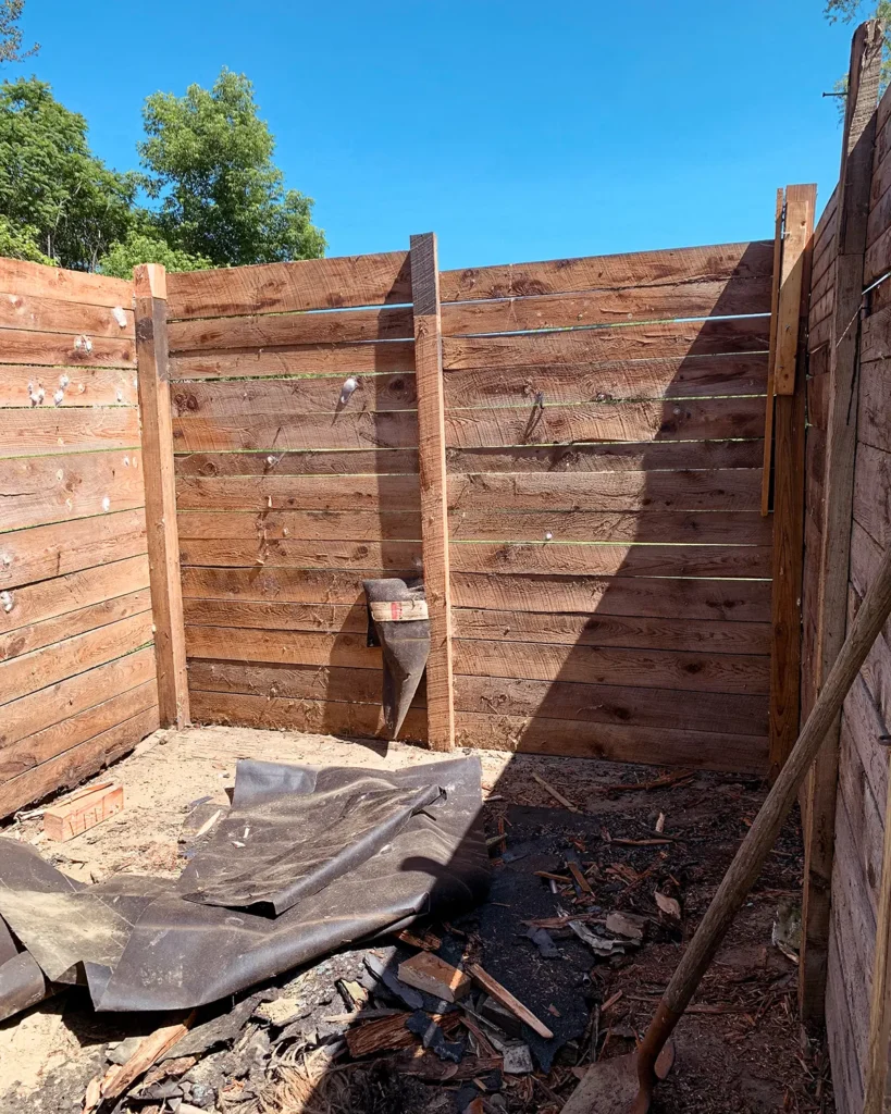 Shed renovation progress photo with the roof and rafters removed from the old flat-roof shed