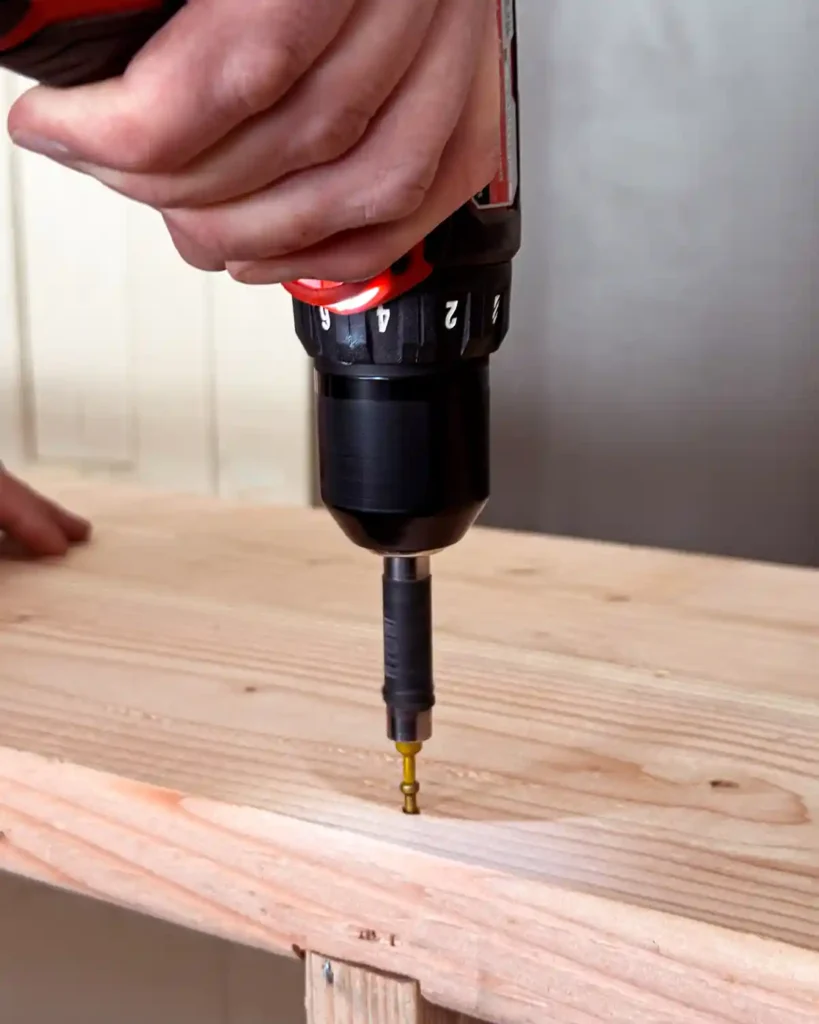 Attaching the top shelf boards of a DIY bookshelf using wood screws