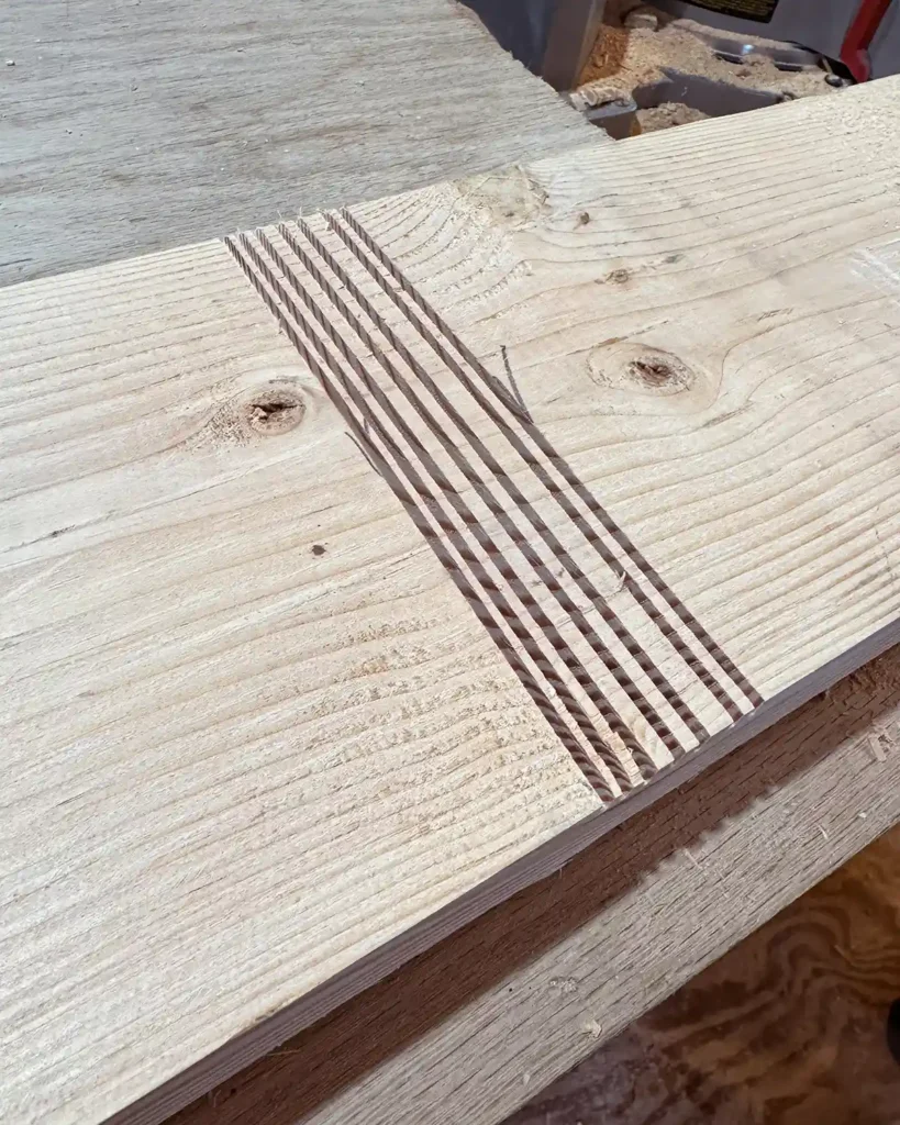 Seven quarter inch grooves cut into a board to create a dado joint