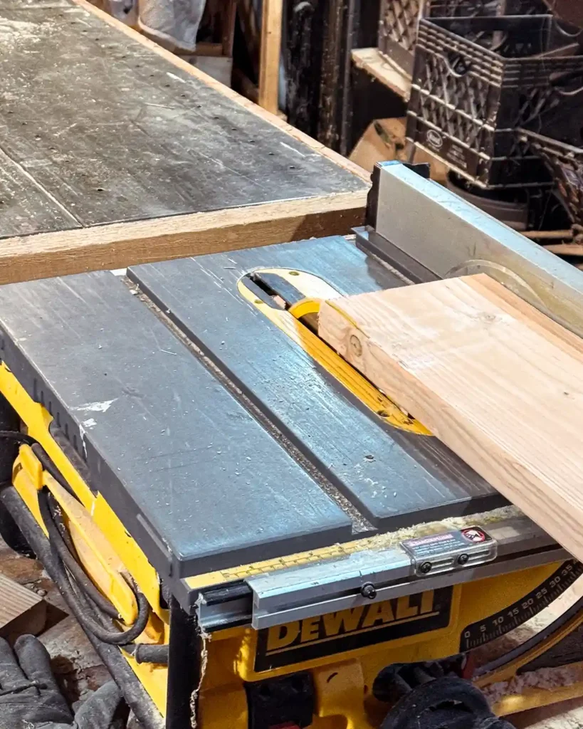 Ripping 2" x 8" fir framing lumber down with a table saw to join two boards together to form one shelf board