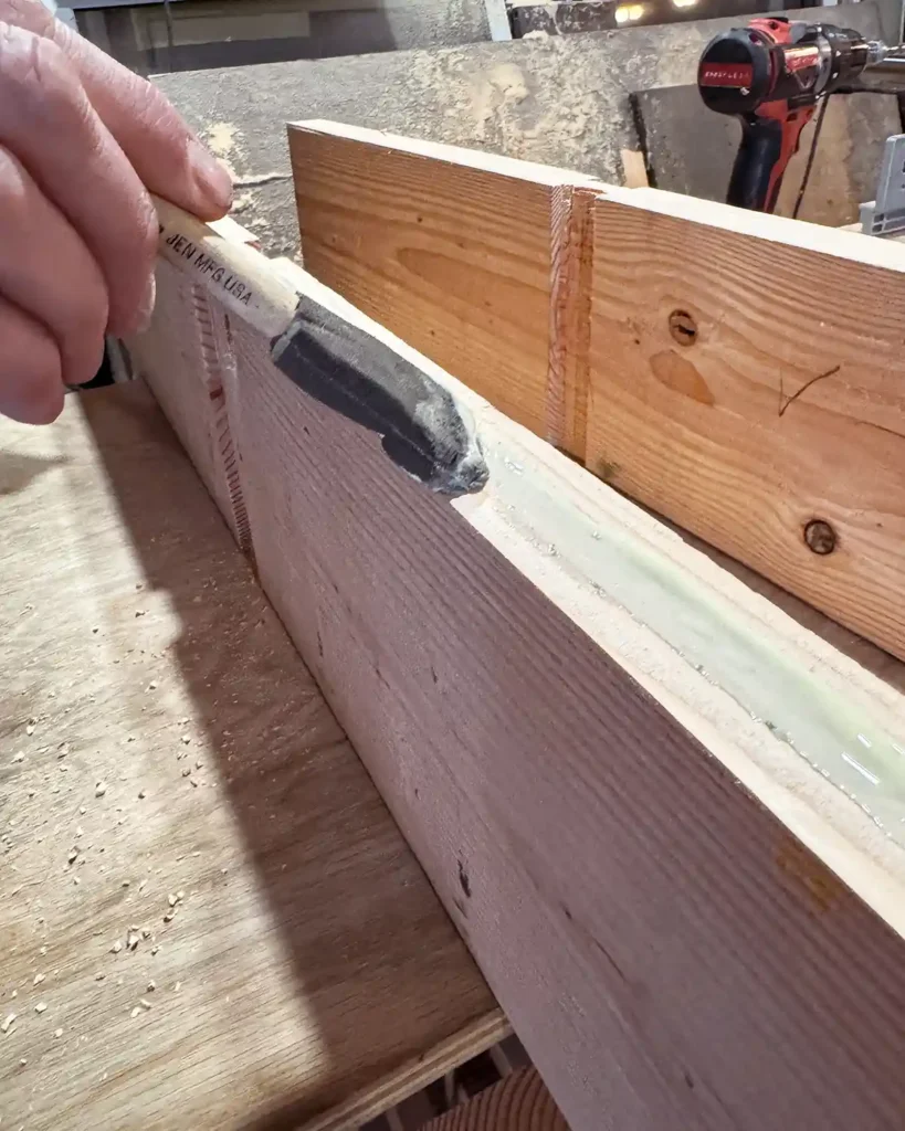 Using wood glue on the edges of the shelf boards before attaching them together
