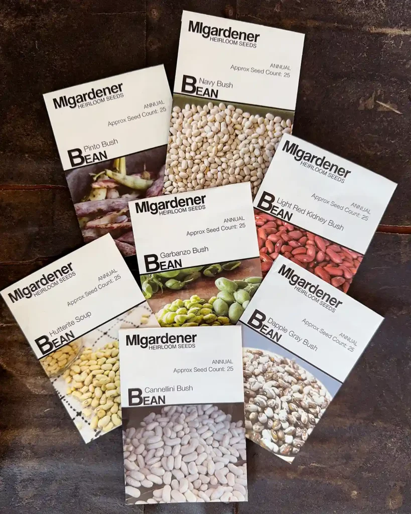 Dry bush bean seed packets for the 2026 planting season featuring Pinto, Navy, Garbanzo, Hutterite Soup, Light Red Kidney, Dapple Gray, and Cannellini Bush Bean seeds