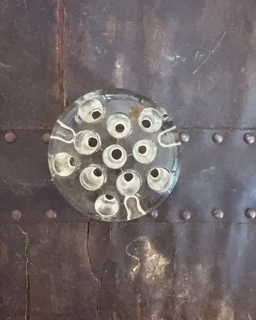 A round, clear, vintage glass flower frog