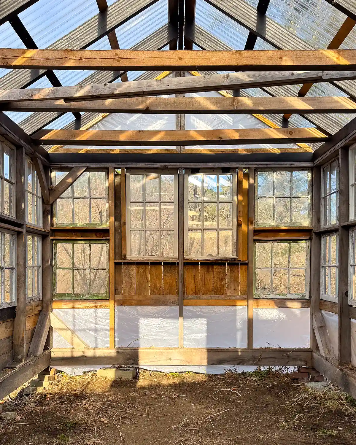 Interior of a window sash greenhouse in the building phase, the structure is all enclosed and now needs siding, paint and finishing the interior