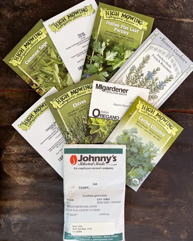 Kitchen herb seed packets for the 2026 planting season featuring Common Sage, Thyme, Italian Flat Leaf Parsley, French Rosemary, Genovese Basil, Chives, Italian Oregano, Caribe Cilantro, and Teddy Dill