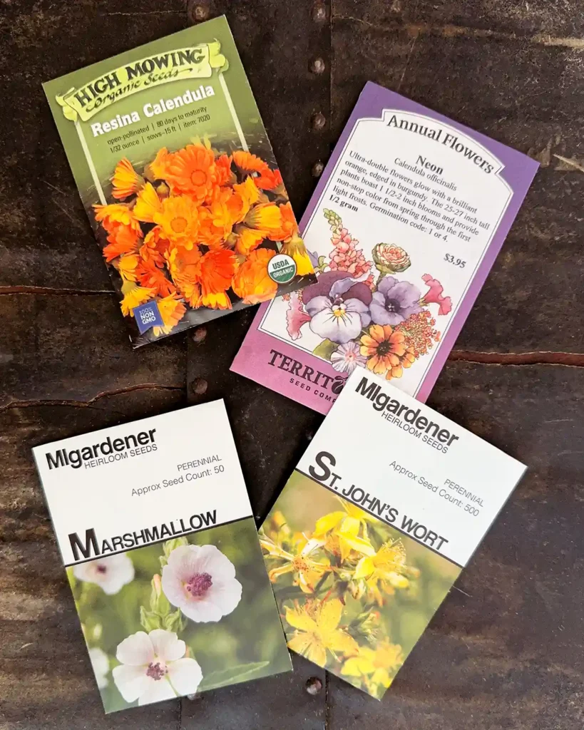 Medicinal herb seed packets for the 2026 planting season featuring Neon Calendula, Resina Calendula, Marshmallow, and St. John's Wort