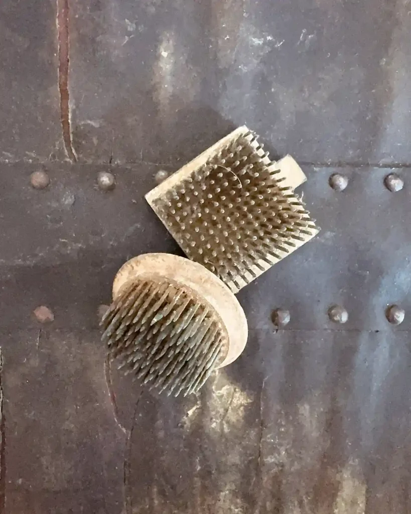 A pair of vintage metal pin flower frogs, one small round one and one small square one