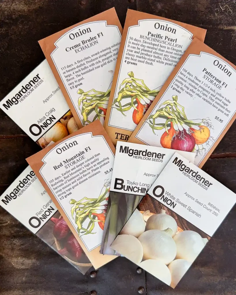 Onion seed packets for the 2026 planting season featuring Ailsa Craig Onion, Creme Brulee Shallot, Pacific Pearl Onion, Patterson Onion, Red Geneva Onion, Red Mountain Onion, Tokyo Long White Bunching Onion, White Sweet Spanish Onion