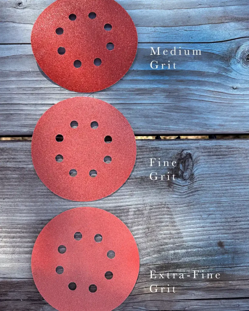 Red orbital sander discs with holes including medium grit, fine grit, and extra-fine grit