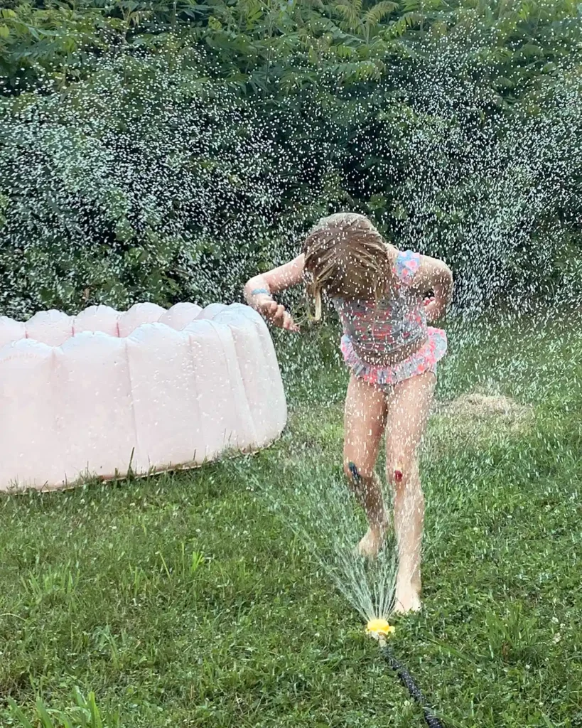 Running through a sprinkler in the spring