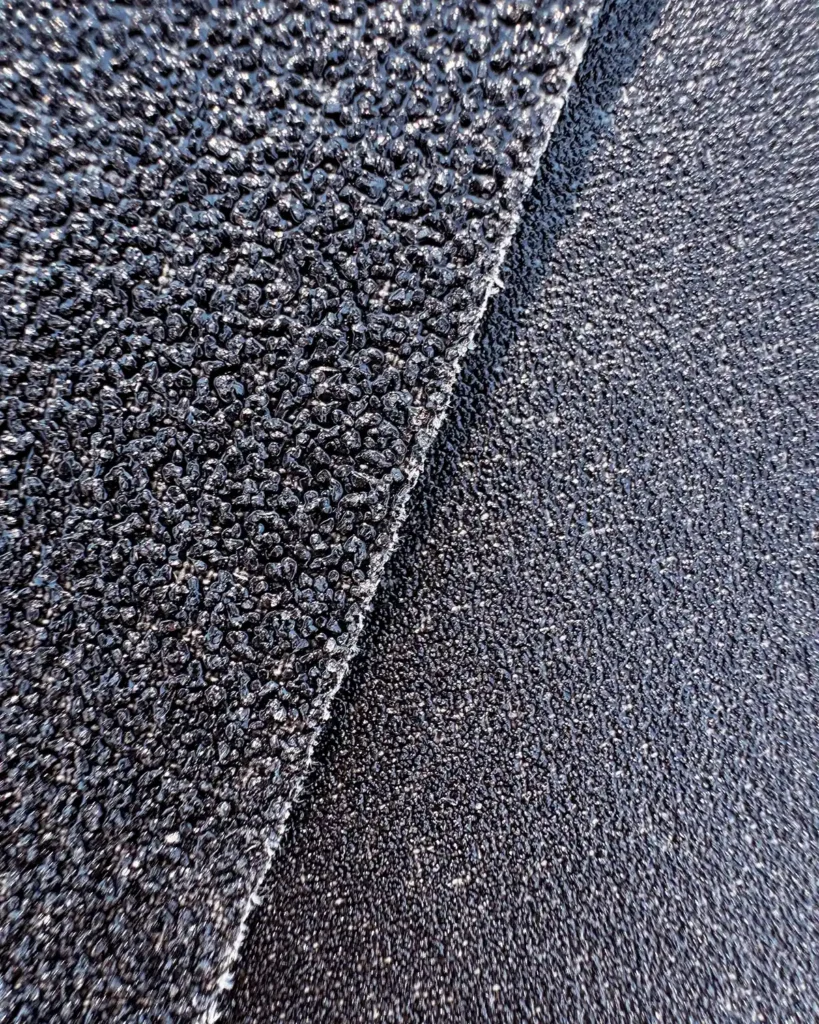 Comparing coarse abrasive grains (on the left) to fine abrasive grains (on the right) on a couple sheets of sandpaper
