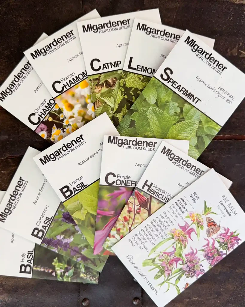 Medicinal herb seed packets for the 2026 planting season featuring German Chamomile, Roman Chamomile, Catnip, Lemon Balm, Spearmint, Holy Basil, Cinnamon Basil, Lemon Basil, Purple Coneflower (Echinacea), Hibiscus, and Bee Balm