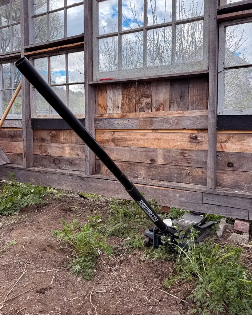 Jacking up a greenhouse structure using a floor jack