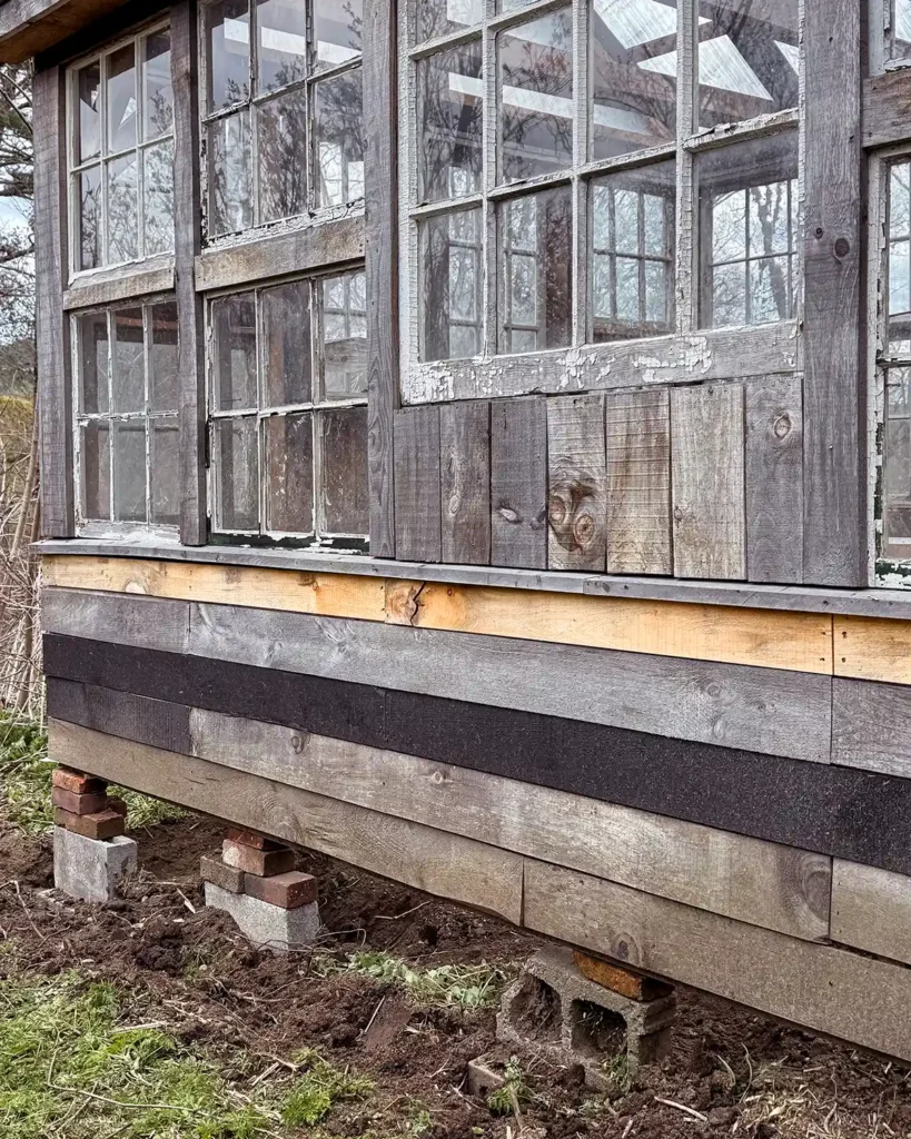 Extra concrete blocks added underneath a greenhouse structure to level the building and keep it from moving or sinking