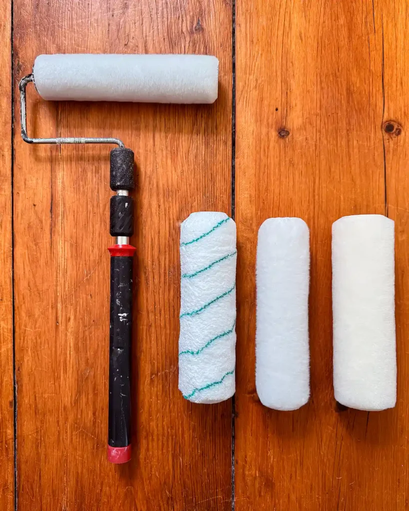 A manual paint roller with a trio of synthetic roller covers in a variety of nap sizes