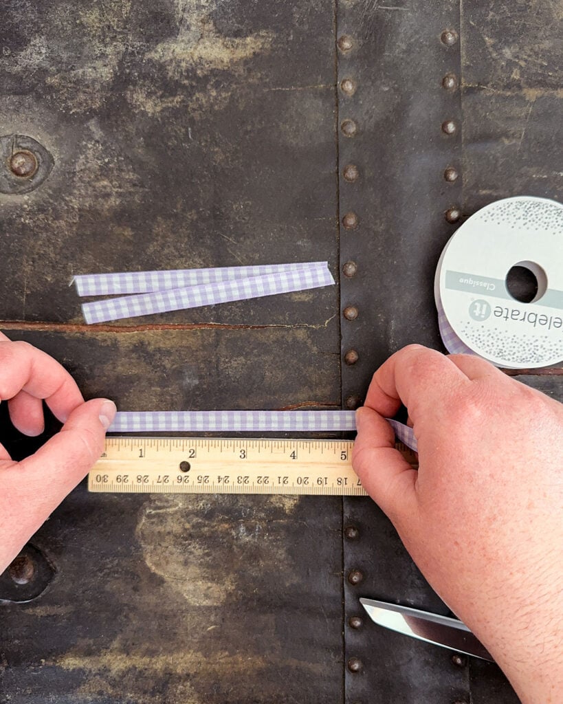 Measuring each piece of ribbon to 4" to 5" lengths and cutting using a pair of fabric scissors