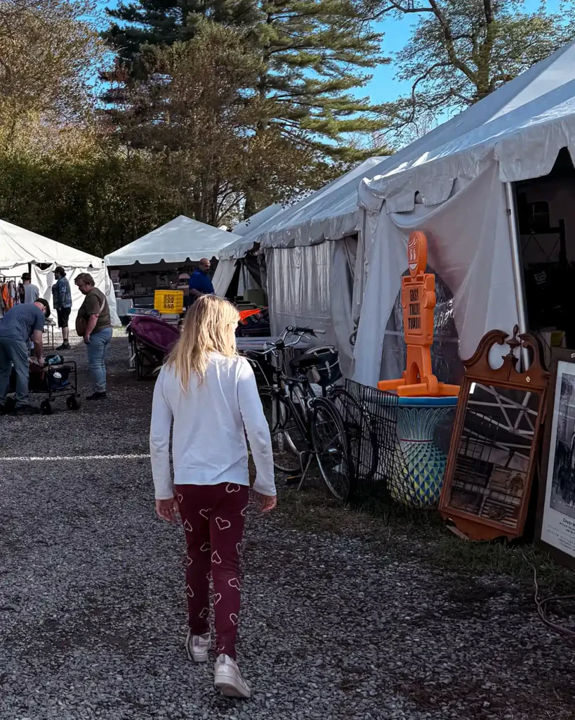 Shopping amongst the vendor booths and tents at Brimfield flea market with my daughter
