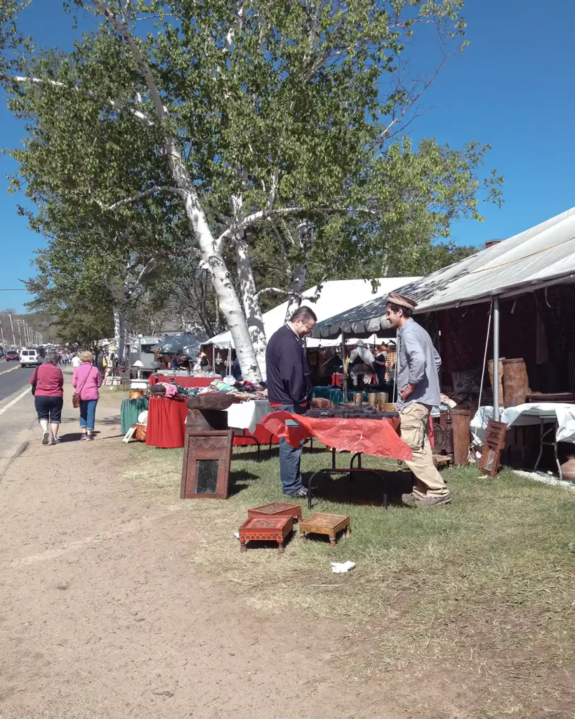 Vintage seller booths lined up along the main road at the Brimfield flea market