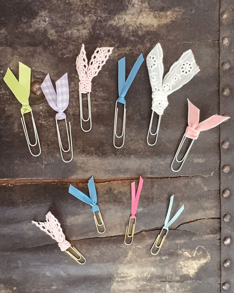 A variety of DIY paperclip bookmarks with different sizes and types of both ribbon and paperclips, from regular size to jumbo paperclips