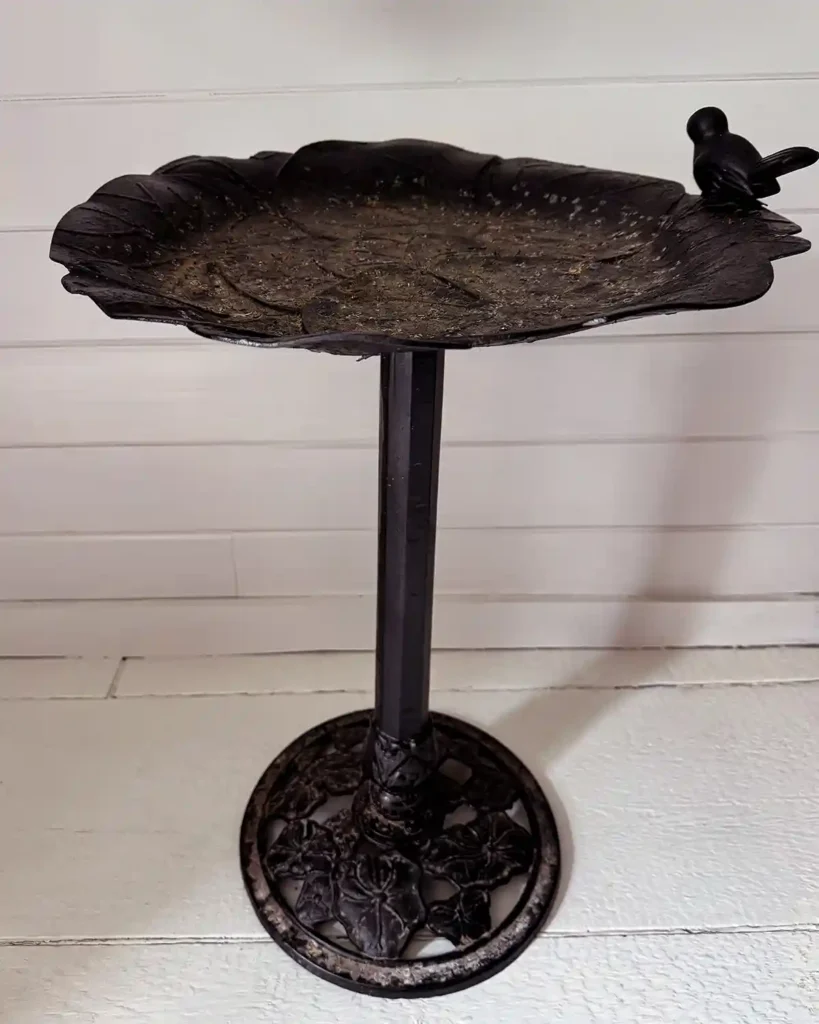 A black metal vintage bird bath found while shopping at the Brimfield flea market in the spring of 2026