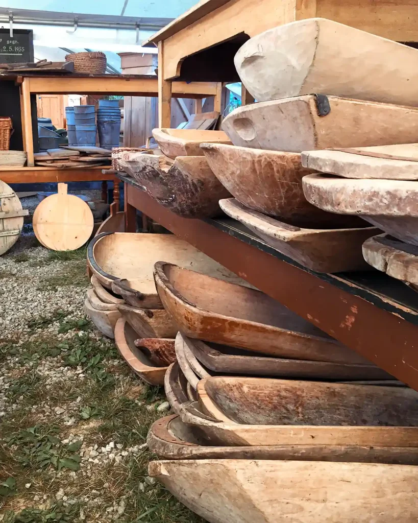 Stacks of wooden vintage dough balls in a vendor booth at the Brimfield antiques show