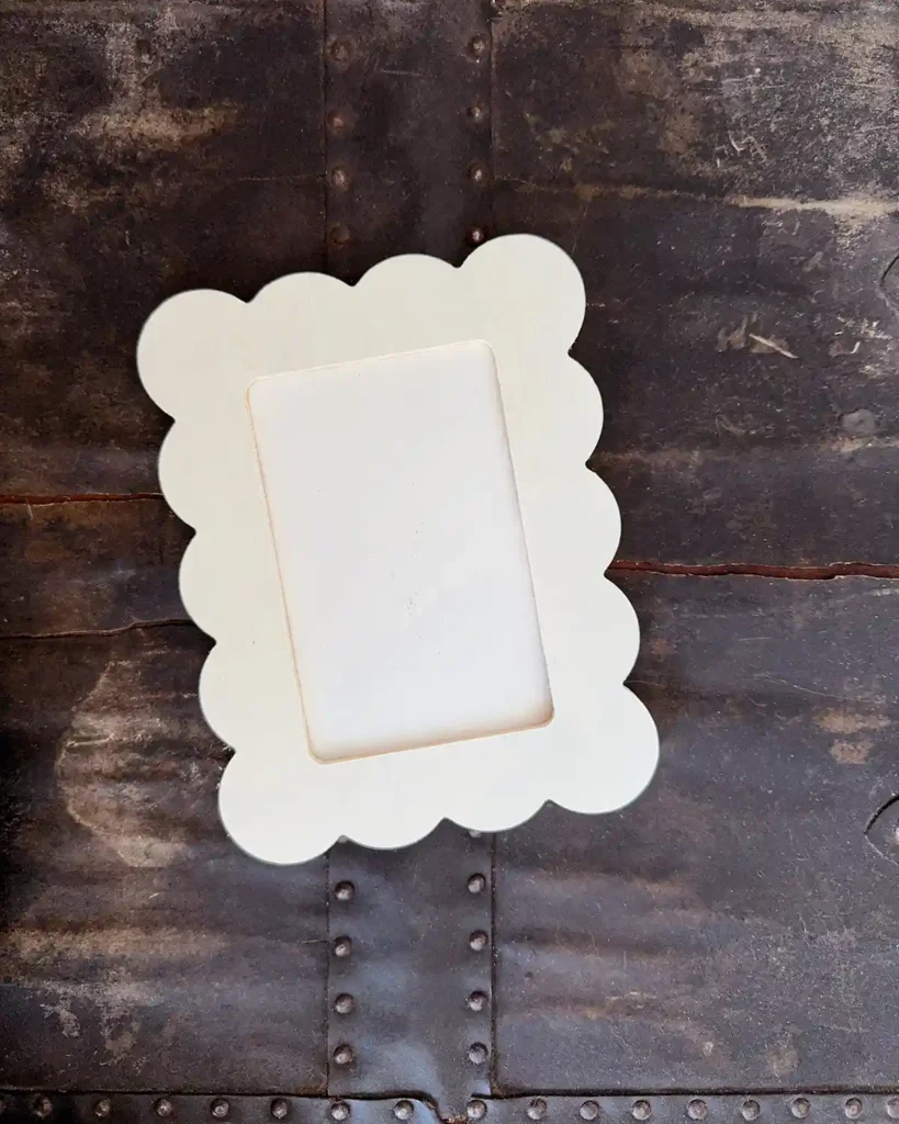 A simple, 4" x 6" scalloped, unfinished wooden frame
