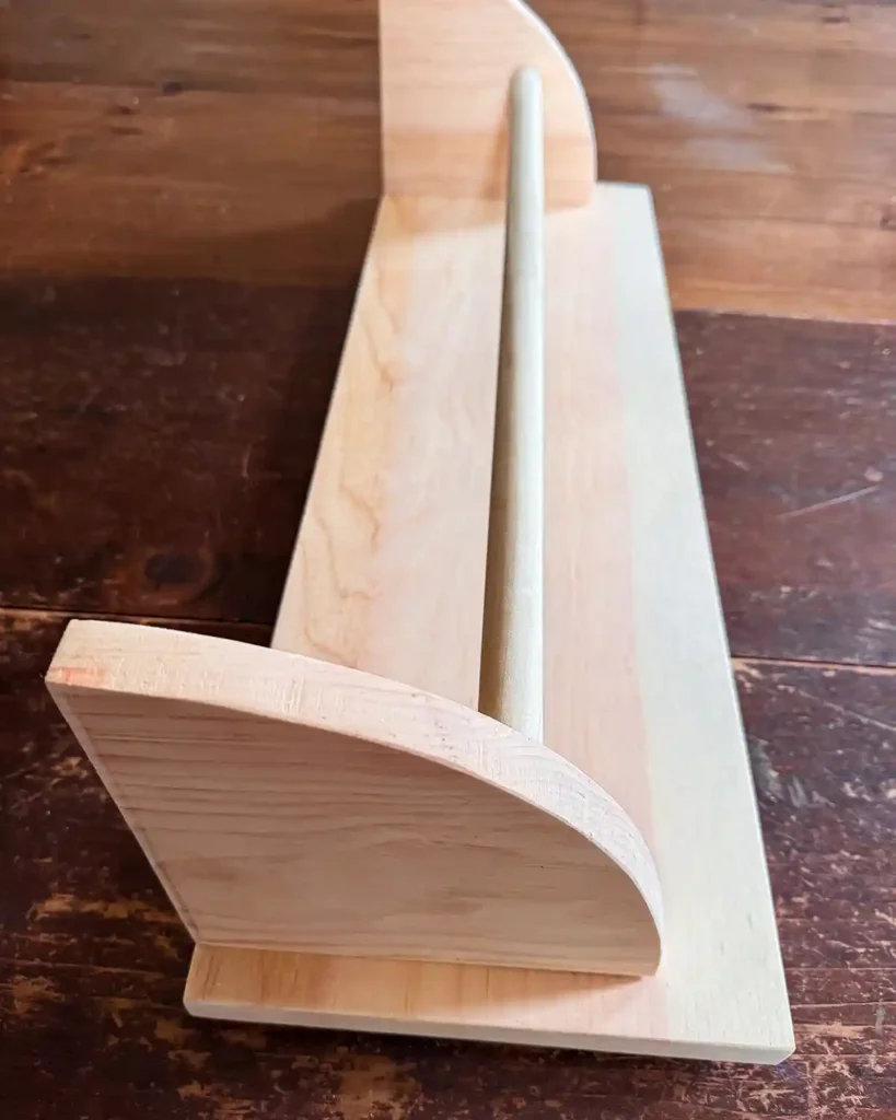 Assembling the unfinished pine, wall-mounted hanging rack; attaching the shelf brackets to the back board