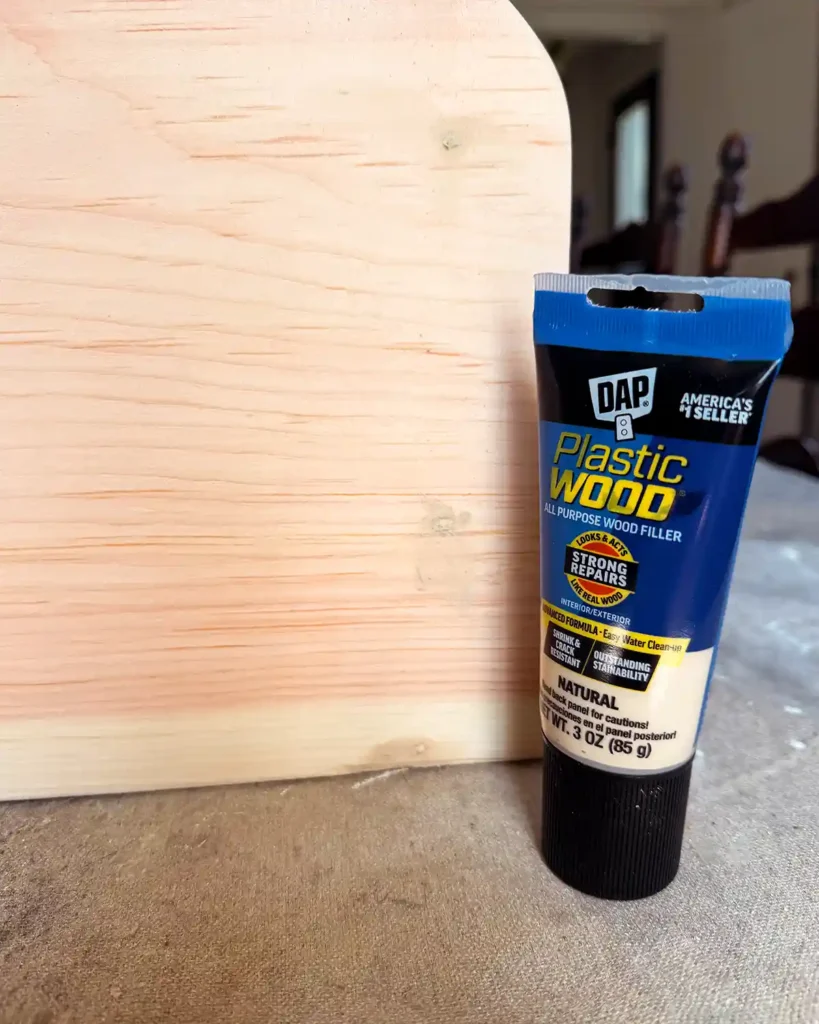 Filling screw head holes in a wooden shelf using natural colored wood filler